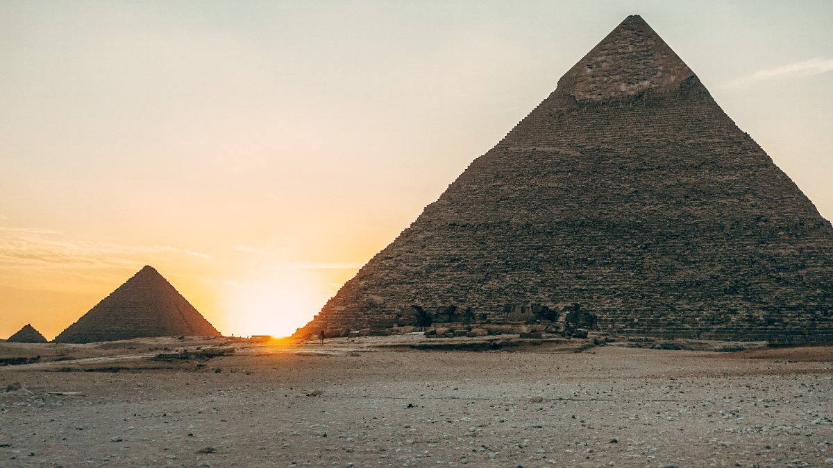 The Pyramids of Giza silhouetted at sunset, Egypt