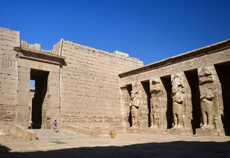 Columns and carved walls in the peristyle court of Ramesses III at Medinet Habu