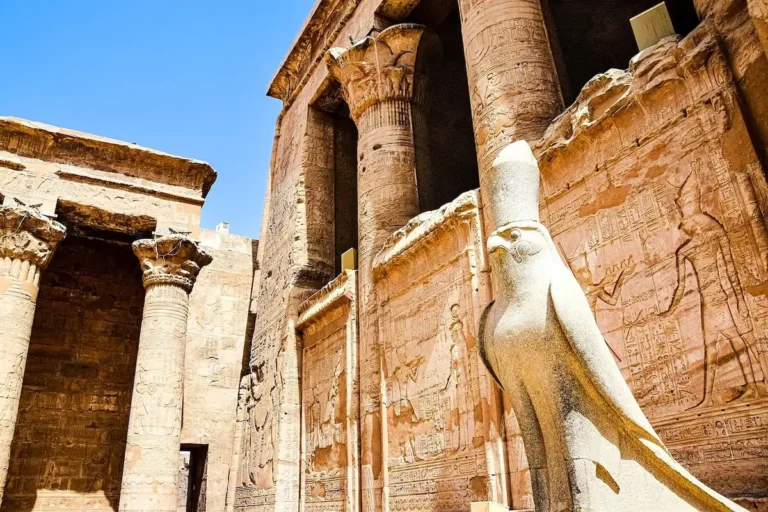 Statue of the falcon god Horus beside the wall of Edfu Temple