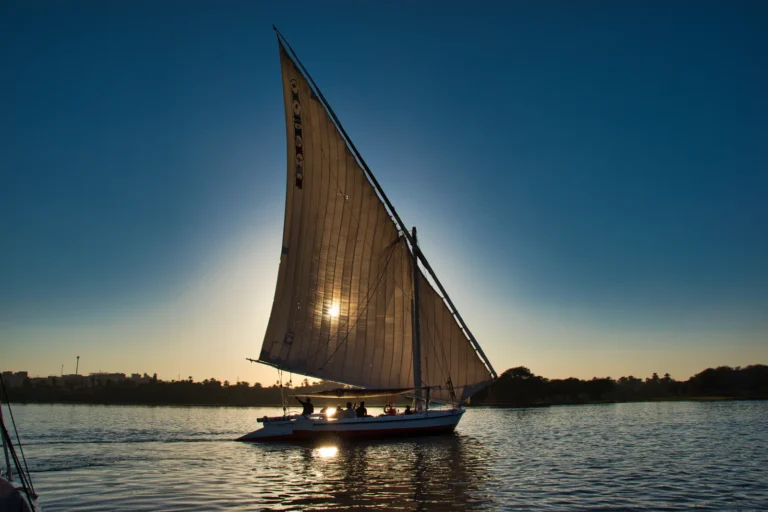 Traditional felucca sailing boat on the Nile at sunset