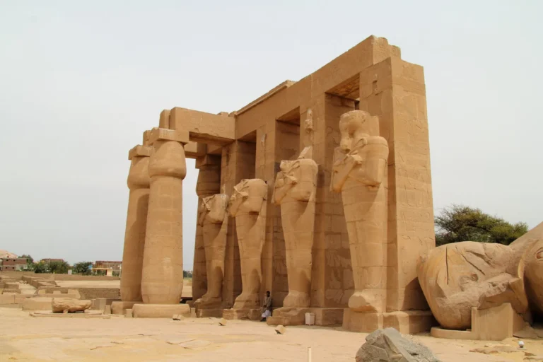 Ramesseum courtyard with Osiride statues and a fallen colossus on the Luxor West Bank